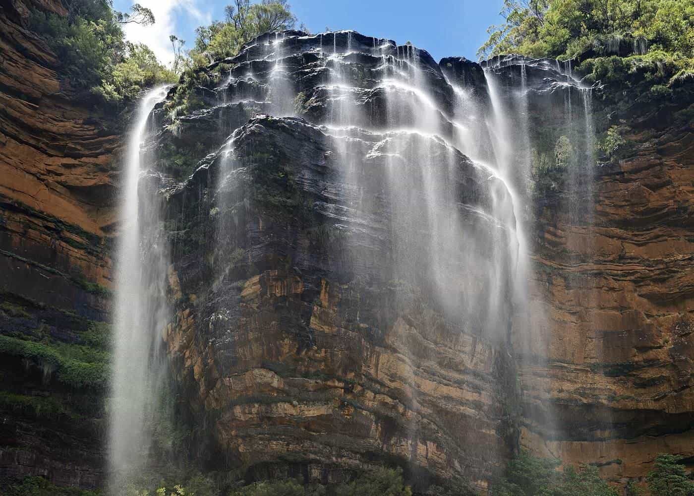 Water falling over sandstone cliffs at Wentworth Falls in the Blue Mountains